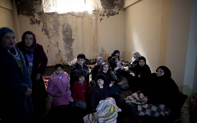 Syrian women and children take shelter from fierce fighting between the Free Syrian Army and government troops in Idlib, north Syria (photo credit:AP/Rodrigo Abd) Syrian women and children take shelter from fierce fighting between the Free Syrian Army and government troops in Idlib, north Syria (photo credit:AP/Rodrigo Abd)