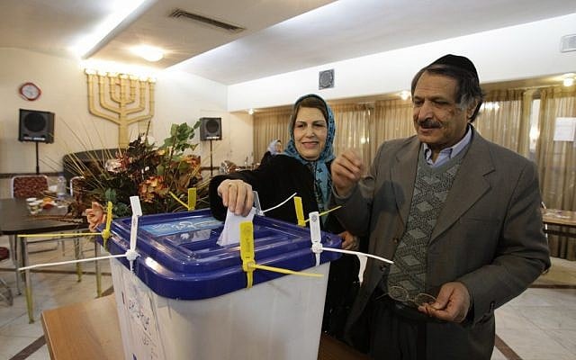 An Iranian Jewish couple casts their ballots for the parliamentary elections, in their polling station, in Tehran, Iran on Friday, March 2, 2012. Under the Iranian constitution Jewish community has one representative in the parliament (photo credit: AP/Vahid Salemi)