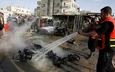 A Palestinian tries to extinguish a fire after an Israeli airstrike in Rafah, southern Gaza Strip, on Saturday (photo credit:Abed Rahim Khatib/Flash 90)