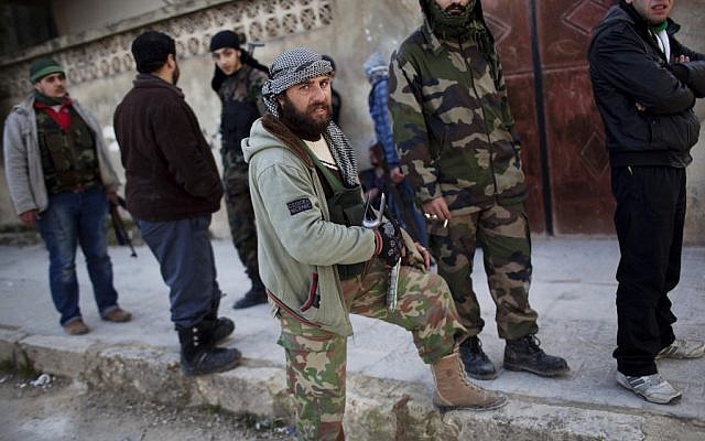 Free Syrian Army fighters gather during fighting against government troops in Idlib, north Syria (photo credit: AP/Rodrigo Abd) Free Syrian Army fighters gather during fighting against government troops in Idlib, north Syria (photo credit: AP/Rodrigo Abd)