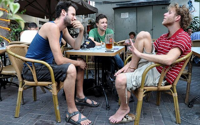 Typical Tel Aviv dudes drink beer at a bar. (photo credit: Nino Herman/Flash90)