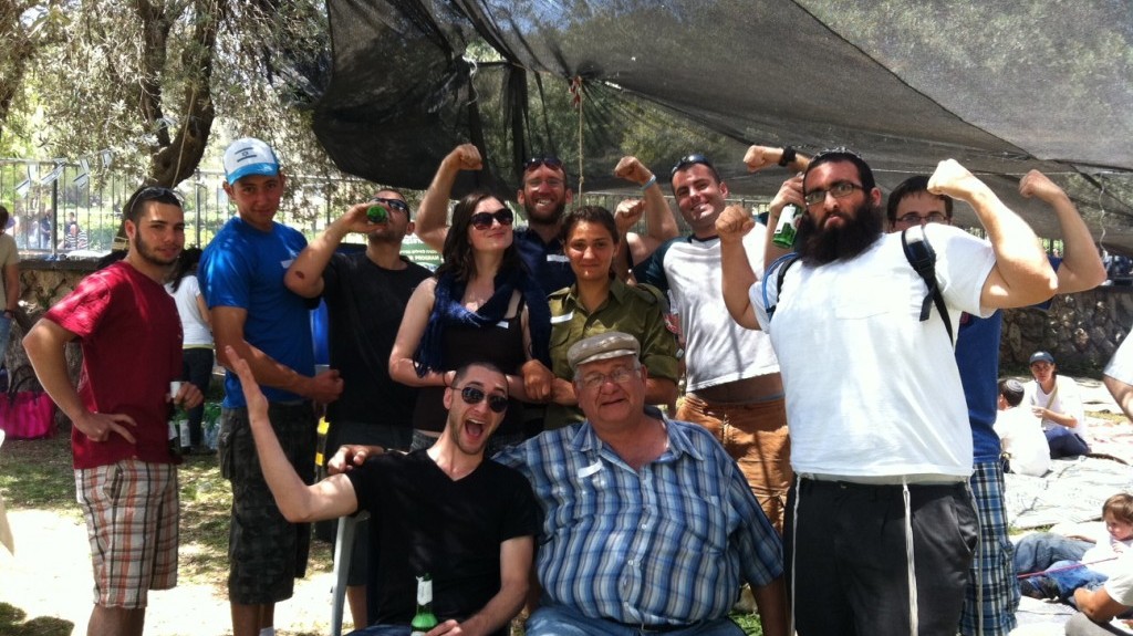 Tziki Aud, center, and his lone soldier "children" at the Sacher Park barbecue in Jerusalem, April 26, 2012 (photo credit: Greg Tepper/Times of Israel)