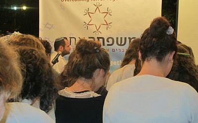 Participants bow their heads during the Memorial Day service at OneFamily (photo courtesy of OneFamily)