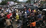 Indonesians stuck in a traffic jam as they flee to higher ground to escape a possible tsunami. (photo credit: AP/Heri Juanda)