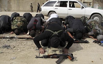 Free Syrian Army fighters perform the noon prayer in a neighborhood of Damascus, Syria (photo credit: AP)