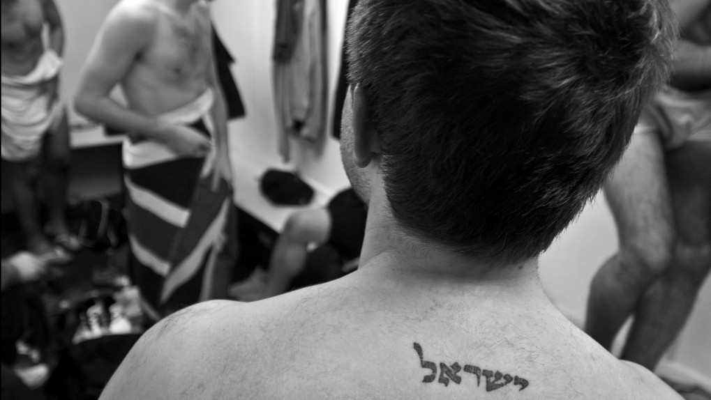 Cheshunt 2010. Maccabi Lions football team changing room after a game.Glasgow 2010. A bar mitzva boy in an Orthodox synagogue waves to his mother who sits in the balcony. (photo credit: Judah Passow)