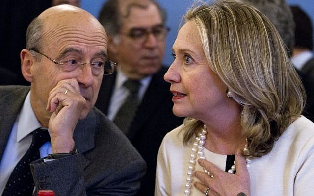 France's Foreign Minister Alain Juppe, left, speaks with US Secretary of State Hillary Rodham Clinton at the start of an “ad hoc” meeting on Syria. (photo credit: AP)