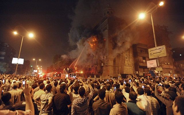 Firemen fight a fire at a church surrounded by angry Muslims in Cairo in 2011 (photo credit: AP)