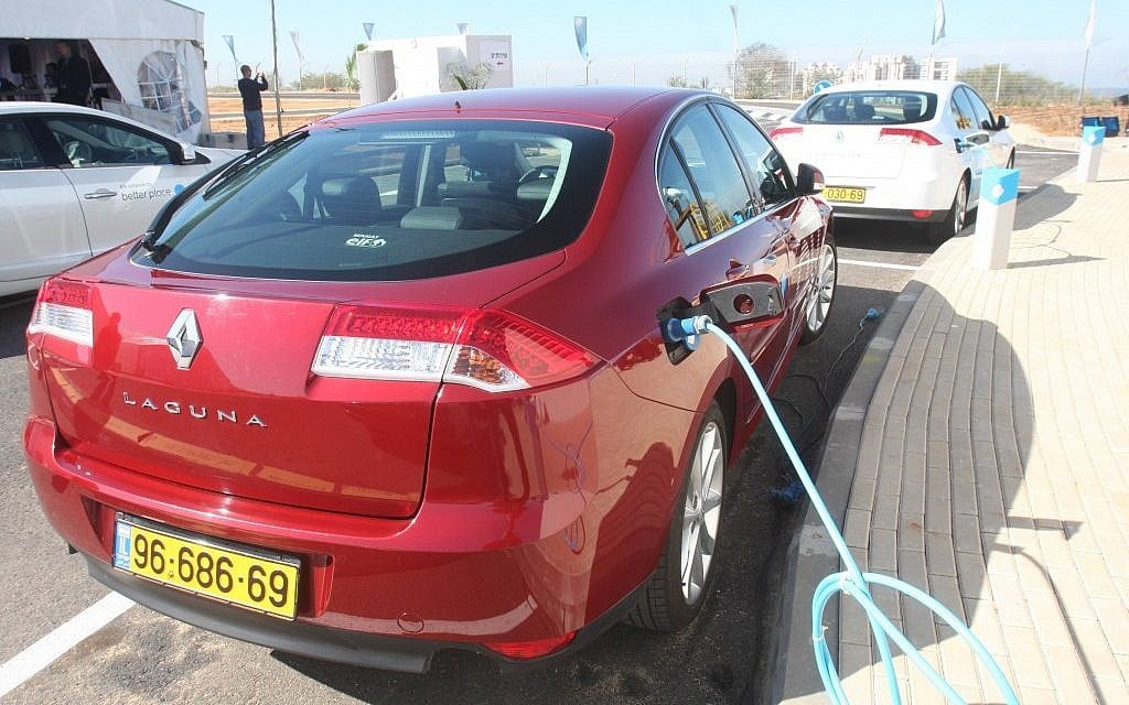 A Renault electric car recharges at a charging station in Ramat Hasharon. (Roni Schutzer/Flash90)