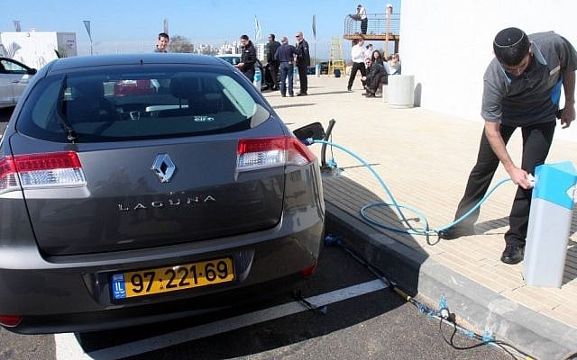 A man refuels a Better Place car marketed by Renault at the company's demonstration center in Ramat Hasharon (photo credit: Roni Schutzer/Flash90) A man refuels a Better Place car marketed by Renault at the company's demonstration center in Ramat Hasharon (photo credit: Roni Schutzer/Flash90)