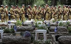 Illustrative photo of soldiers standing near the graves of fallen comrades at the Mount Herzl military cemetery, Jerusalem, ahead of Memorial Day, 2012. (photo credit: Gili Yaari/Flash90)