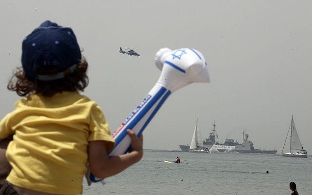 A child watches the naval flotilla during last year's Independence Day celebrations (photo credit: Abir Sultan/Flash90)