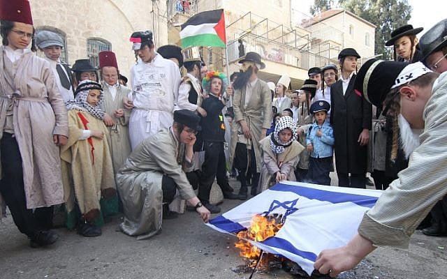 Neturei Karta activists wave a Palestinian flag as they burn the Israeli flag in the Meah Shearim neighborhood of Jerusalem on Purim last year. (photo credit: Nati Shohat/Flash90) Neturei Karta activists wave a Palestinian flag as they burn the Israeli flag in the Meah Shearim neighborhood of Jerusalem on Purim last year. (photo credit: Nati Shohat/Flash90)
