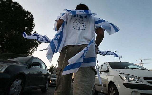 Selling flags to drivers is an annual tradition before Independence Day (photo credit: Kobi Gideon/Flash90)