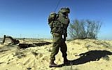An Israeli soldier secures infrastructure work on the Israeli-Egyptian border fence (photo credit: Tsafrir Abayov/Flash90)