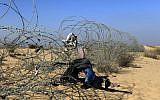The border fence between Israel and Egypt with clothing left during illegal crossings (photo credit: Tsafrir Abayov/Flash90)