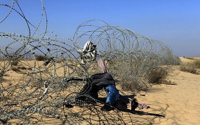 The border fence between Israel and Egypt with clothing left during illegal crossings (photo credit: Tsafrir Abayov/Flash90) The border fence between Israel and Egypt with clothing left during illegal crossings (photo credit: Tsafrir Abayov/Flash90)