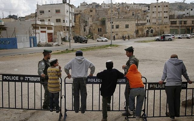 A soldier stands guard outside Beit Hamachpela last week (photo credit: Miriam Alster/Flash90)