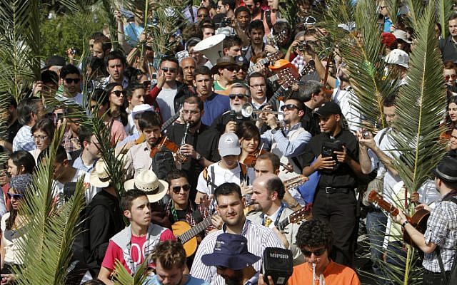 Christian pilgrims participate in the traditional Palm Sunday procession on Jerusalem's Mount of Olives. (photo credit: Miriam Alster/Flash90)