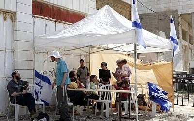The settlers evicted from Beit Hamachpela in Hebron pitch a tent near the property on Thursday. (photo credit: Uri Lenz/Flash90)