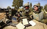Israeli soldiers read from the Passover Hagaddah (photo credit: Edi Israel/Flash90)