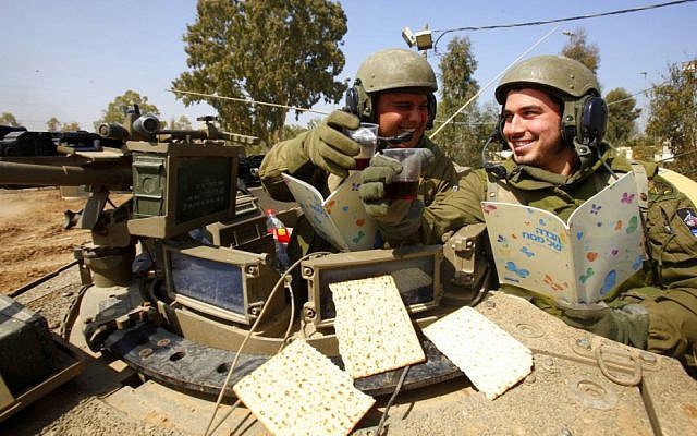 Israeli soldiers read from the Passover Hagaddah (photo credit: Edi Israel/Flash90)