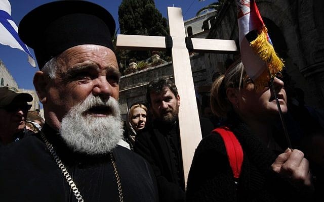 Christian worshipers hold crosses during a Good Friday procession on the Via Dolorosa in Jerusalem's Old City. (illustrative photo credit: Miriam Alster/Flash90)
