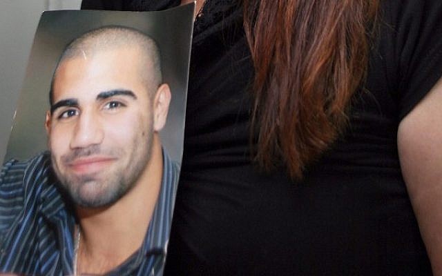 Laurence Amsis, in a picture held by his mother in court on Tuesday. (photo credit: Gidon Markowitz/Flash90)