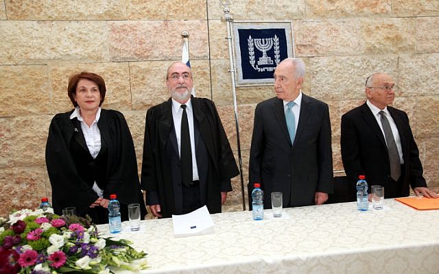Justice Minister Yaakov Neeman (right), President Shimon Peres (center) and Supreme Court President Asher Grunis (second from the left) at a swearing-in ceremony for new judges in Jerusalem. (photo credit: Yossi Zamir/Flash90)