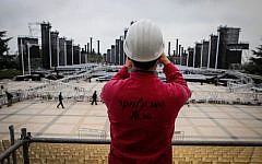 An investigator looks out over the scene at Mount Herzl where a large platform stage collapsed, killing a young woman and injuring several more on Wednesday. (photo credit: Uri Lenz/Flash90)