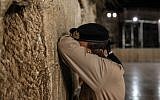 A soldier at the Western Wall Tuesday night. (Photo credit: Noam Moskowitz/Flash90)