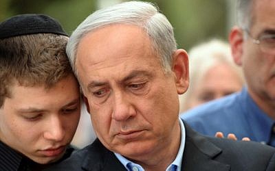 Prime Minister Benjamin Netanyahu with his son Yair at the funeral of Netanyahu's father, Benzion, in Jerusalem, on Monday. (photo credit: Avi Ohayon/GPO/Flash90)