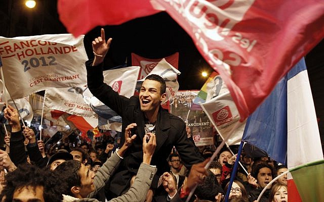 Supporters of Socialist candidate Francois Hollande celebrate in Paris (photo credit: AP/Laurent Cipriani) Supporters of Socialist candidate Francois Hollande celebrate in Paris (photo credit: AP/Laurent Cipriani)