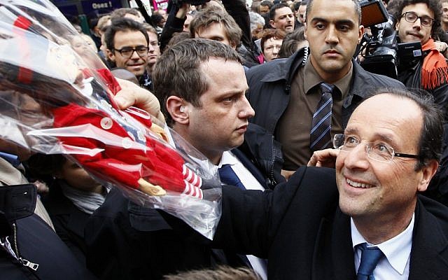 French Socialist Party presidential candidate Francois Hollande greets the crowd during a campaign meeting in northern France on Wednesday. (photo credit: Francois Mori/AP)
