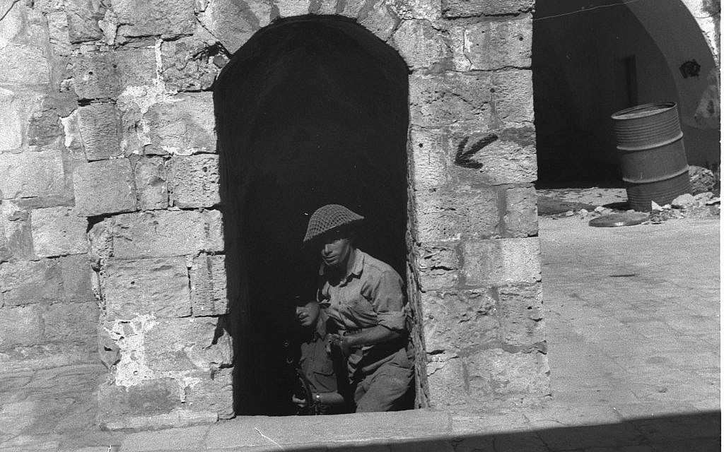 Jewish fighters outside the Old City walls, 1948. (Courtesy of the Government Press Office, Jerusalem)