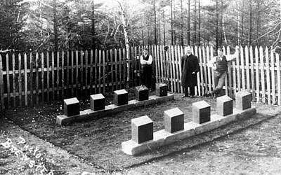 A photograph taken at the Titanic section in the Baron de Hirsch Cemetery in Halifax, Nova Scotia, in November 1912. Left to right: Frank Fitzgerald, a man believed to be Rabbi Jacob Walter, and Fred Bishop, who was responsible for ordering, cutting, and engraving stone, per a contract with the White Star Line. (photo credit: Russ Lownds via the John P. Eaton/Charles A. Haas Titanic Photograph Archive) 