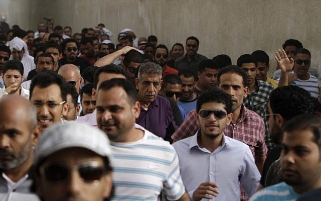 Bahraini anti-government protesters are chased by riot police throwing stun grenades through a narrow street outside the British Embassy in Manama. (photo credit: AP/Hasan Jamali) Bahraini anti-government protesters are chased by riot police throwing stun grenades through a narrow street outside the British Embassy in Manama. (photo credit: AP/Hasan Jamali)