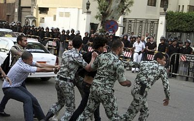 A protester is detained by security forces in front of the Saudi Embassy in Cairo, April 28, 2012 (photo credit: Ahmed Gomaa/AP)