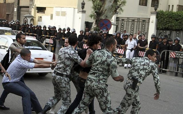 A protester is detained by security forces in front of the Saudi Embassy in Cairo, April 28, 2012 (photo credit: Ahmed Gomaa/AP)