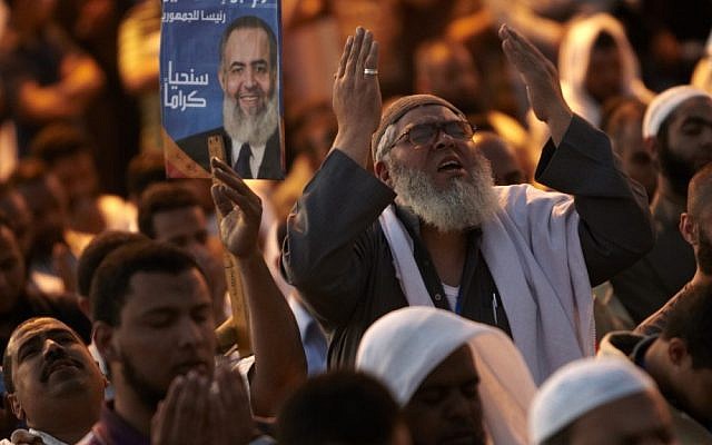The day after tens of thousands of demonstrators packed Cairo's downtown Tahrir Square in the biggest demonstration in months against the ruling military, followers of Egyptian Muslim cleric and former presidential candidate Hazem Abu Ismail perform their evening prayer as they continue the protest. (photo credit: Fredrik Persson/AP) The day after tens of thousands of demonstrators packed Cairo's downtown Tahrir Square in the biggest demonstration in months against the ruling military, followers of Egyptian Muslim cleric and former presidential candidate Hazem Abu Ismail perform their evening prayer as they continue the protest. (photo credit: Fredrik Persson/AP)