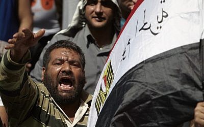 A protester chants slogans in Tahrir Square in Cairo, Friday. (photo credit: AP)