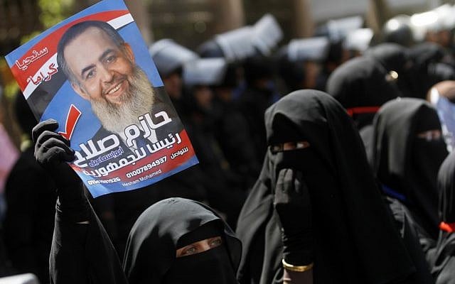 Egyptian supporters of potential presidential candidate Hazem Abu Ismail gather outside a courtroom in Cairo, Egypt, on Wednesday (photo credit: AP/Khalil Hamra) Egyptian supporters of potential presidential candidate Hazem Abu Ismail gather outside a courtroom in Cairo, Egypt, on Wednesday (photo credit: AP/Khalil Hamra)