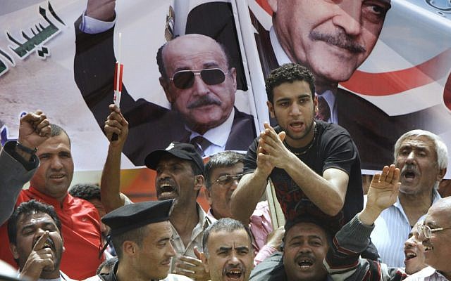 Supporters of former Egyptian vice president Omar Suleiman's presidential campaign in Cairo, Egypt, on April 8, 2012. (photo credit: AP/Amr Nabil) Supporters of former Egyptian vice president Omar Suleiman's presidential campaign in Cairo, Egypt, on April 8, 2012. (photo credit: AP/Amr Nabil)