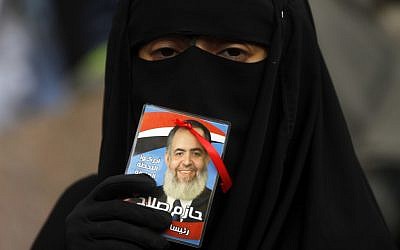An Egyptian woman holds a picture of a potential presidential candidate (AP Photo/Khalil Hamra)