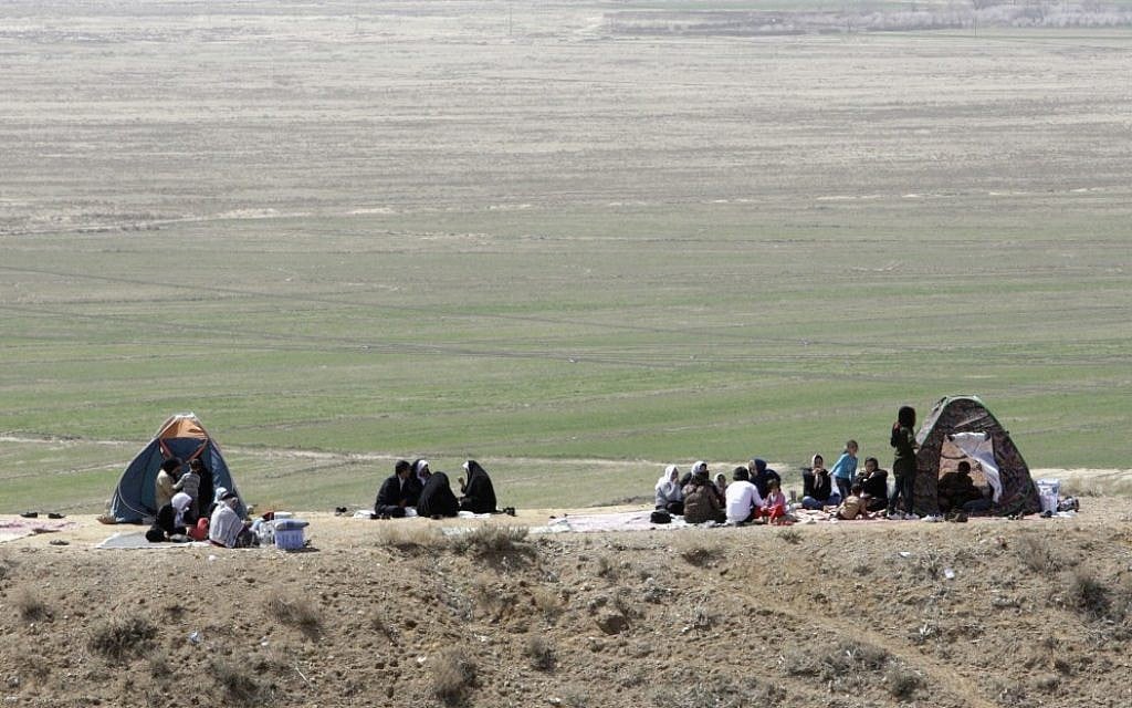 Iranian families celebrating the ancient festival of Sizdeh Bedar outdoors. (photo credit: AP/Vahid Salemi)