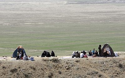Iranian families celebrating the ancient festival of Sizdeh Bedar outdoors. (photo credit: AP/Vahid Salemi)