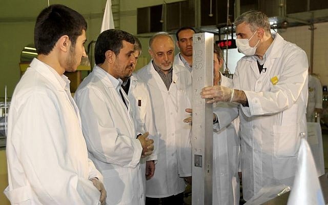 File photo, released by the Iranian President's Office, shows Iranian President Mahmoud Ahmadinejad during a tour of Tehran's research reactor center (photo credit: AP/Iranian President's Office, File)
