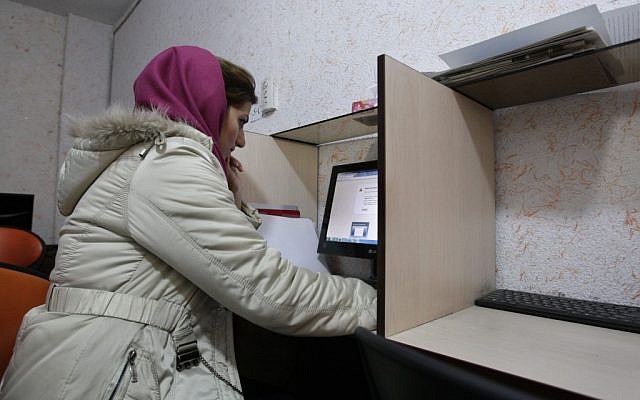 Illustrative photo of a Muslim woman wearing a head cover at an internet cafe in central Tehran. (photo credit: Vahid Salemi/AP) Illustrative photo of a Muslim woman wearing a head cover at an internet cafe in central Tehran. (photo credit: Vahid Salemi/AP)
