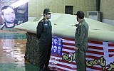 Chief of the aerospace division of Iran's Revolutionary Guards Amir Ali Hajizadeh (left), near a captured US RQ-170 Sentinel drone in April 2012. (photo credit: AP/Sepahnews)