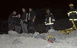 Police stand next to a rocket that landed in Eilat in early April 2012 (photo credit: AP/Yehuda Ben Itah)